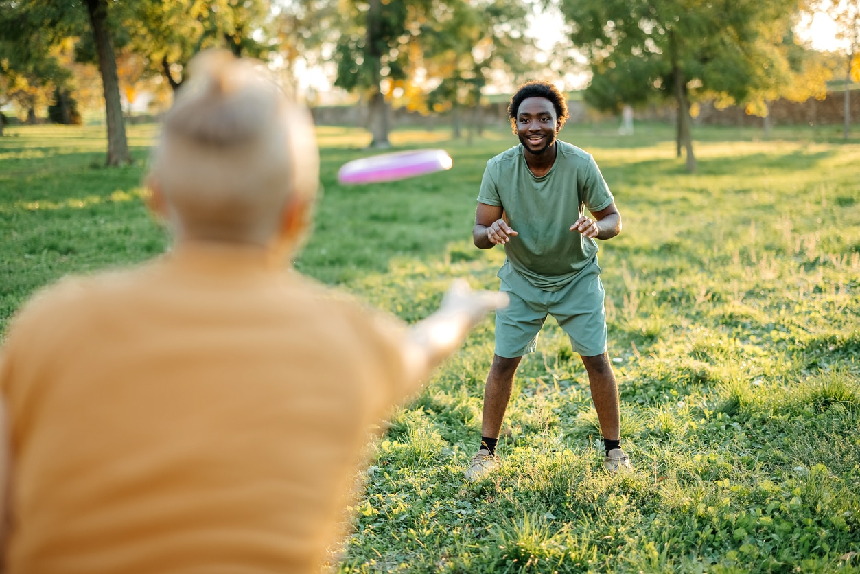 Couple are playing frisbee at the park.