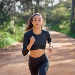 Fitness, running and woman in nature for exercise, marathon training and cardio workout in morning.